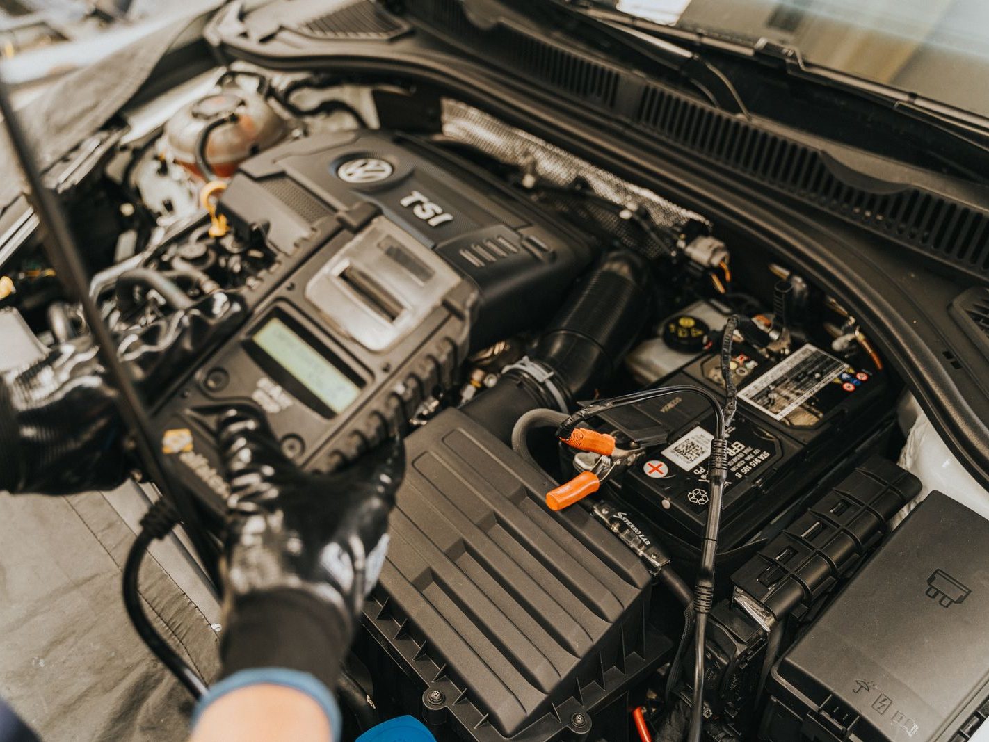 Diagnostic tester connected to a turbocharged European engine bay